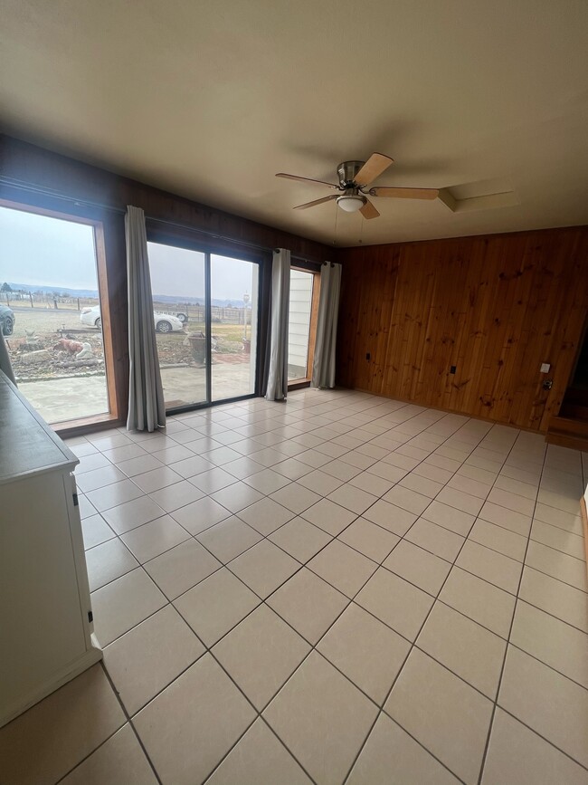 Living room has sliding door for easy access to front porch area. - 881 Bishop Rd