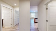 This thoughtfully designed 1-bedroom, 2-bathroom residence in Ellicott City, Maryland offers a clean, modern aesthetic throughout its efficiently utilized single-floor layout. Light wood-look flooring flows through the main living areas, complemented by crisp white walls and recessed lighting that create a bright, welcoming ambiance.

The kitchen is the standout feature of the home, showcasing warm wood cabinetry, a subway tile backsplash, and a granite-topped island with an integrated sink and dishwasher. A trio of sleek pendant lights hangs above the island, while stainless steel appliances — including a refrigerator, range, and microwave — complete the space. Natural light from a nearby window enhances the open connection between the kitchen and living area.

The bedroom offers a comfortable, carpeted retreat with a large window that fills the room with natural light. It includes access to a walk-in closet outfitted with wire shelving for organized storage. Two full bathrooms serve the home, one featuring a tiled tub-shower combo, wood-toned vanity, and white countertop.

A dedicated laundry room with full-size washer and dryer adds everyday convenience, and a hallway connects all areas of the home seamlessly. The overall design is clean, functional, and move-in ready.