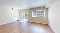 Located at 607 47th Street Southeast in Everett, WA, this one-bedroom, one-bathroom unit offers a well-designed, efficiently organized floor plan. The open-concept living and kitchen area is anchored by warm wood-style flooring that extends throughout the entire space, creating a cohesive and welcoming atmosphere.

The kitchen is a standout feature, equipped with stainless steel appliances including a refrigerator, electric range, and over-the-range microwave. Crisp white shaker-style cabinetry and speckled quartz countertops provide both function and a clean, modern aesthetic. Recessed lighting illuminates the workspace effectively.

The living area is bright and open, benefiting from a sliding glass door that leads to an outdoor space and a large window that invites natural light. The clean, neutral walls complement the light flooring and provide a versatile backdrop.

The bedroom is a comfortable size, featuring a wide double-door closet for ample storage and a window with a view of the surrounding neighborhood. The bathroom is finished with a full tub-and-shower combination, a white vanity with a quartz-style countertop, and consistent wood-style flooring. Throughout the unit, the design is clean, modern, and move-in ready.