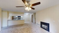 Located at 454 Crestmont Ct in Copley, Ohio, this 2-bedroom, 2-bathroom single-floor residence offers a thoughtfully designed layout with a comfortable, neutral aesthetic throughout. The open-concept living and dining area serves as the heart of the home, featuring plush wall-to-wall carpeting, warm cream-toned walls, and a ceiling fan with light fixture. A standout gas fireplace with a tile surround anchors the living room, adding both warmth and visual interest. Sliding glass doors lead to a private balcony, filling the space with natural light and providing outdoor access. The kitchen is well-equipped with white cabinetry, granite-look countertops, and stainless steel appliances including a refrigerator, electric range, and over-the-range microwave, all set on durable tile flooring. Both bedrooms are carpeted and generously sized, with the primary bedroom offering a large window overlooking greenery. The two full bathrooms feature tiled flooring, tub-shower combinations, and white vanities. Additional conveniences include multiple closets for ample storage, laundry facilities, a utility room, and a hallway connecting the living spaces seamlessly.