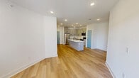 Located at 3818 Page Road in Morrisville, NC, this well-appointed 2-bedroom, 2-bathroom residence offers a thoughtfully designed single-floor layout that balances comfort and modern style. Light-toned hardwood flooring flows throughout, creating a bright and cohesive aesthetic enhanced by crisp white walls and clean-lined trim.

The kitchen is a standout feature, outfitted with grey shaker-style cabinetry, black hardware accents, a white quartz peninsula with an undermount sink, subway tile backsplash, and a full suite of stainless steel appliances including a refrigerator, range, and microwave. Recessed lighting keeps the space well-lit and functional.

Both bedrooms are generously proportioned, each featuring ceiling fans and access to closets with wire shelving systems for organized storage. The primary bedroom offers windows with outdoor views and access to a private balcony. Three closets in total provide ample storage throughout the residence.

The two bathrooms are finished in a clean, modern palette. One features a walk-in shower with a sleek black-framed glass enclosure, while the other offers a full tub-shower combination — both appointed with black fixture accents, white vanities, and recessed lighting.

Accented throughout by teal-painted interior doors, the space carries a distinctive, contemporary character that sets it apart.