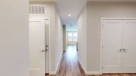 Located at 1900 S Hanover St in Baltimore's South Baltimore neighborhood, this one-bedroom, one-bathroom unit offers a thoughtfully designed layout with modern finishes throughout. Warm hardwood-style flooring runs continuously through every room, creating a cohesive and inviting atmosphere from the moment you enter.

The entrance hallway leads naturally into the open living and kitchen area. The kitchen is a standout feature, boasting crisp white cabinetry extending to the ceiling, a classic white subway tile backsplash, light quartz countertops, a peninsula with an integrated sink, and a full suite of stainless steel appliances including a refrigerator, range, microwave, and dishwasher — providing ample function and style for everyday cooking.

The spacious primary bedroom is generously sized, bathed in natural light from a large window with exterior views, and offers a calm, neutral palette with clean lines that make it easy to personalize. Recessed lighting and ceiling fixtures are present throughout the unit, ensuring well-lit spaces at all hours.

The bathroom is finished with light neutral tile flooring, large-format wall tile in the tub surround, a full soaking tub with shower, a modern white vanity with ample drawer storage, and polished chrome fixtures. The overall design of this unit is clean, contemporary, and move-in ready.