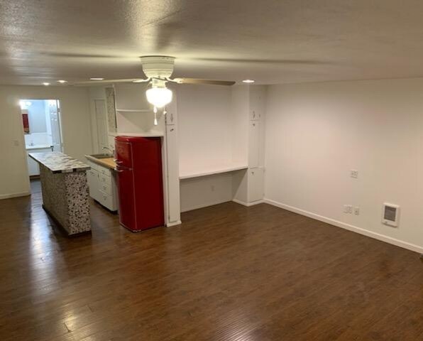 View from living room of kitchenette with a mid sized sink and retro red fridge - 521 SE Cook Plant Farm Rd