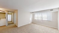 Located at 816 Lawrence Dr in Newark, Delaware, this single-floor, 3-bedroom, 2-bathroom home offers a practical and well-organized layout. The living area is bright and open, featuring neutral-toned carpet flooring and a large window fitted with vertical blinds that invites natural light into the space.

The kitchen is efficiently designed with rich dark-wood cabinetry, light stone countertops, a double sink, and tile flooring. Black appliances — including a refrigerator, range, and dishwasher — complete the kitchen's cohesive look.

Each of the three carpeted bedrooms features neutral walls and individual closets with built-in shelving for storage. The primary bedroom is the most spacious of the three and benefits from dual windows, filling the room with natural light. The additional bedrooms are cozy and well-suited for various uses.

The two bathrooms are clean and functional, featuring tile flooring, dark-wood vanities with white countertops, and a full tub-shower with white tile surround. A dedicated laundry area houses a full-size washer and dryer, adding everyday convenience. A hallway connects the rooms, creating a smooth flow throughout the home.