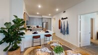Located at 3000 Van Buren Blvd in Riverside, California, this single-floor residence offers a thoughtfully designed open-concept layout with cohesive modern finishes throughout. The main living area is bright and welcoming, featuring wood-look plank flooring, recessed lighting, and a ceiling fan, with seamless flow into the dining and kitchen spaces. The kitchen is well-equipped with gray shaker-style cabinetry, white quartz countertops, a classic subway tile backsplash, stainless steel appliances including a gas range and refrigerator, and a breakfast bar with bar seating — ideal for both casual dining and entertaining. An adjoining dining area provides additional space for sit-down meals. The bedrooms are comfortably sized, each featuring plush carpeting, ceiling fans, and windows that bring in natural light with views of the surrounding community. A bold teal accent wall in one bedroom adds a distinctive design element, while convenient en-suite bathroom access enhances functionality. The bathrooms are finished with gray cabinetry, dual-sink vanities topped with white quartz, wood-look tile flooring, and ample storage. An in-unit laundry area completes the practical offerings of this well-rounded residence.