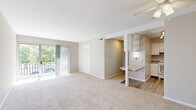 Located at 412 Thurber Dr W in Columbus, Ohio, this single-floor unit offers three bedrooms and one bathroom within a well-organized layout. The living room is generously proportioned, featuring soft carpeting, neutral gray walls, and a ceiling fan. A sliding glass door opens onto a private balcony, flooding the space with natural light and offering pleasant views of surrounding greenery. The kitchen is efficiently designed with white cabinetry, granite-style countertops, a hardwood-style vinyl floor, and white appliances including a range and refrigerator. A pass-through window connects the kitchen to the living area, enhancing the open feel. The three bedrooms are carpeted and finished in neutral tones, each offering adequate space for furnishings. The primary bedroom includes closet access, while additional bedrooms feature windows with natural light. One bedroom is equipped with dual closets, providing ample storage. The shared bathroom is well-appointed with a marble-style tiled tub-shower combination, wood-look flooring, a white vanity with granite-style countertops, and a towel bar. A dedicated closet adds further storage convenience to the overall layout.