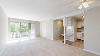 Located at 412 Thurber Dr W in Columbus, Ohio, this single-floor unit offers three bedrooms and one bathroom within a well-organized layout. The living room is generously proportioned, featuring soft carpeting, neutral gray walls, and a ceiling fan. A sliding glass door opens onto a private balcony, flooding the space with natural light and offering pleasant views of surrounding greenery. The kitchen is efficiently designed with white cabinetry, granite-style countertops, a hardwood-style vinyl floor, and white appliances including a range and refrigerator. A pass-through window connects the kitchen to the living area, enhancing the open feel. The three bedrooms are carpeted and finished in neutral tones, each offering adequate space for furnishings. The primary bedroom includes closet access, while additional bedrooms feature windows with natural light. One bedroom is equipped with dual closets, providing ample storage. The shared bathroom is well-appointed with a marble-style tiled tub-shower combination, wood-look flooring, a white vanity with granite-style countertops, and a towel bar. A dedicated closet adds further storage convenience to the overall layout.