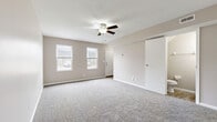 Located in Kettering, Ohio, this two-story, 2-bedroom, 2-bathroom home offers a thoughtfully arranged layout spread across two floors. The main level features a welcoming living room finished with soft carpeting, a ceiling fan, and dual windows that bring in natural light and views of the neighborhood. The galley-style kitchen is well-equipped with white cabinetry, laminate countertops, wood-look flooring, white appliances including a refrigerator and range, and a peninsula that opens toward a staircase. A sliding door in the kitchen leads directly to a private patio with outdoor views. The lower level also includes a bathroom with wood-look flooring and a dark-toned vanity. Upstairs, the generously sized primary bedroom features plush carpeting, a ceiling fan, and a window with tree-lined views. The second bedroom is equally comfortable with carpet and natural light. A full bathroom on the upper level offers a tub-shower combo with a clean, white surround. Two closets provide practical storage throughout the home. Warm neutral tones and consistent finishes create a cohesive, move-in-ready atmosphere throughout this well-organized Kettering residence.