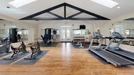 Imagine waking up every day with a world-class fitness center just steps away. This extraordinary 1,000 square foot space in San Ramon is not just a room—it's a gateway to your best self. Soaring ceilings with exposed beams create an inspiring atmosphere, while skylights flood the area with invigorating natural light. The thoughtfully designed layout accommodates a wide range of workout styles, from cardio to strength training.

High-end exercise equipment, including treadmills, stationary bikes, and weight machines, stands ready to support your fitness journey. The beautiful hardwood floors add warmth and elegance, seamlessly blending functionality with style. Ample mirrors help you perfect your form, while the spacious layout ensures you never feel cramped during your workouts.

This isn't just a gym—it's a sanctuary for health and wellness. The French doors invite the outdoors in, offering glimpses of nature to keep you motivated. With this incredible amenity at your fingertips, you're not just buying a property; you're investing in a lifestyle of wellness, convenience, and luxury. Embrace the opportunity to prioritize your health and transform your daily routine in this exceptional space that brings the best of fitness right to your doorstep.