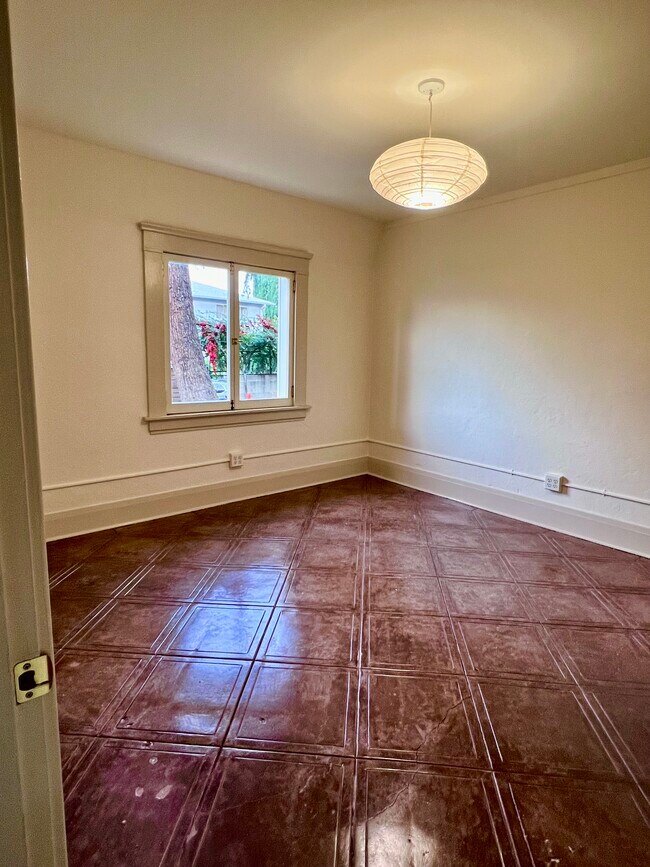 Bedroom #1 with cut concrete floors and garden view - 1342 Edgecliffe Dr