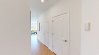 Located at 268 Market St in South Burlington, Vermont, this contemporary 2-bedroom, 2-bathroom residence offers a thoughtfully designed single-floor layout filled with natural light. The open-concept living and kitchen area serves as the heart of the home, featuring light hardwood flooring throughout, white shaker cabinetry, stainless steel appliances, and a central island with seating — ideal for both cooking and entertaining. Large, multi-pane windows flood the space with sunlight and offer views of the surrounding neighborhood and greenery. The living area provides a comfortable, airy atmosphere with a wall-mounted mini-split unit for climate control. Both bedrooms are well-proportioned with clean white walls, hardwood floors, and double-door closets. The primary bedroom features its own mini-split unit and bright windows, while the second bedroom benefits from dual windows with tree-lined views. Each bathroom is finished with white vanities, light wood-tone flooring, and shower setups. A dedicated closet adds practical storage. The overall aesthetic is clean, modern, and bright — reflecting a move-in-ready residence designed for comfortable urban living in South Burlington.