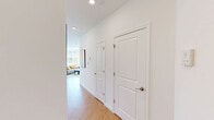 Located at 268 Market St in South Burlington, Vermont, this contemporary 2-bedroom, 2-bathroom residence offers a thoughtfully designed single-floor layout filled with natural light. The open-concept living and kitchen area serves as the heart of the home, featuring light hardwood flooring throughout, white shaker cabinetry, stainless steel appliances, and a central island with seating — ideal for both cooking and entertaining. Large, multi-pane windows flood the space with sunlight and offer views of the surrounding neighborhood and greenery. The living area provides a comfortable, airy atmosphere with a wall-mounted mini-split unit for climate control. Both bedrooms are well-proportioned with clean white walls, hardwood floors, and double-door closets. The primary bedroom features its own mini-split unit and bright windows, while the second bedroom benefits from dual windows with tree-lined views. Each bathroom is finished with white vanities, light wood-tone flooring, and shower setups. A dedicated closet adds practical storage. The overall aesthetic is clean, modern, and bright — reflecting a move-in-ready residence designed for comfortable urban living in South Burlington.