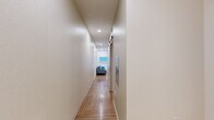 Located at 1501 S Acoma St in Denver, Colorado, this efficiently designed one-bedroom, one-bathroom unit makes thoughtful use of its compact footprint. The open-concept living area greets you with warm hardwood-style flooring, crisp white walls, and recessed lighting that keeps the space feeling bright and airy. Large windows fitted with roller shades invite natural light while a wall-mounted HVAC unit ensures year-round comfort. The living area flows seamlessly into a functional kitchen equipped with light wood cabinetry, a stainless steel sink, and full appliances including a range and refrigerator — ideal for everyday use.

The bedroom features a distinctive angled ceiling that lends architectural character to the intimate space, complemented by recessed lighting, a ceiling fan, and warm neutral tones. The hardwood-style flooring continues throughout, maintaining a cohesive aesthetic.

The bathroom is clean and modern, featuring a full tub-shower combination with white subway-style tile surround, a floating wood vanity with a white countertop, and brushed nickel fixtures throughout. A hallway connects the rooms, adding a sense of flow and separation between living and sleeping areas. This well-appointed unit offers a thoughtfully organized layout suited for efficient, comfortable living in Denver's South Broadway neighborhood.