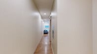 Located at 1501 S Acoma St in Denver, Colorado, this efficiently designed one-bedroom, one-bathroom unit makes thoughtful use of its compact footprint. The open-concept living area greets you with warm hardwood-style flooring, crisp white walls, and recessed lighting that keeps the space feeling bright and airy. Large windows fitted with roller shades invite natural light while a wall-mounted HVAC unit ensures year-round comfort. The living area flows seamlessly into a functional kitchen equipped with light wood cabinetry, a stainless steel sink, and full appliances including a range and refrigerator — ideal for everyday use.

The bedroom features a distinctive angled ceiling that lends architectural character to the intimate space, complemented by recessed lighting, a ceiling fan, and warm neutral tones. The hardwood-style flooring continues throughout, maintaining a cohesive aesthetic.

The bathroom is clean and modern, featuring a full tub-shower combination with white subway-style tile surround, a floating wood vanity with a white countertop, and brushed nickel fixtures throughout. A hallway connects the rooms, adding a sense of flow and separation between living and sleeping areas. This well-appointed unit offers a thoughtfully organized layout suited for efficient, comfortable living in Denver's South Broadway neighborhood.