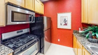 Located in the heart of Los Angeles, this single-floor residence at 1221 W Third St offers a well-appointed layout designed for comfortable urban living. The spacious living room features plush carpeting, crown molding, and warm ambient lighting, creating an inviting atmosphere. A sliding glass door opens directly onto a private balcony, bringing in natural light and views of lush surrounding greenery.

The kitchen is equipped with stainless steel appliances, including a gas range, built-in microwave, and refrigerator, complemented by light wood cabinetry, granite countertops, and tile flooring. A bold accent wall adds a vibrant design touch to the space.

The bedrooms are generously sized with soft carpeting and large windows dressed in elegant striped curtains, allowing natural light to filter in while maintaining privacy. Each bedroom offers views of the exterior balcony and courtyard.

The bathrooms are thoughtfully designed with textured wood-tone wall treatments, granite vanity countertops, and tile flooring. One bathroom features a combined tub and shower with glass sliding doors, while the second includes a standalone glass-enclosed shower, built-in cabinetry, and a bright window. Together, the spaces create a cohesive, warm, and functional home in a prime Los Angeles location.