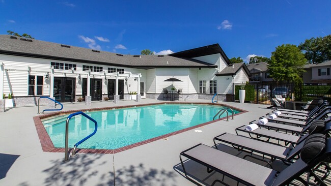 Relájese en las tumbonas junto a la piscina y tome sol, rodeado de un entorno de piscina exquisitamente diseñado, un santuario de relajación. - Greystone Woods