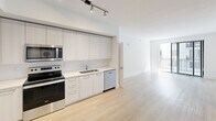 Located at 101 W Camino Real in the heart of Boca Raton, FL, this modern 2-bedroom, 4-bathroom apartment offers a clean, contemporary design throughout. Light wood-tone flooring flows seamlessly across the entire single-level layout, creating a warm and cohesive aesthetic.

The open kitchen is outfitted with floor-to-ceiling light wood cabinetry, stainless steel appliances including a French door refrigerator, range, microwave, and dishwasher, along with white quartz countertops and track lighting overhead. The space transitions naturally into the open living area, which receives natural light through a large sliding glass door leading to a balcony.

Each bedroom features ceiling fans, neutral walls, and generous natural light. The spacious primary bedroom includes its own dedicated bathroom and closet. Both bedrooms are served by well-appointed bathrooms, each finished with light wood vanity cabinetry, white quartz countertops, and large mirrors. One bathroom showcases a floor-to-ceiling tiled walk-in glass shower with a built-in bench. Closets are equipped with wire shelving systems for organized storage.

The overall ambiance is bright, minimal, and move-in ready, reflecting a modern Florida lifestyle in a prime Boca Raton location.