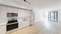 Located at 101 W Camino Real in the heart of Boca Raton, FL, this modern 2-bedroom, 4-bathroom apartment offers a clean, contemporary design throughout. Light wood-tone flooring flows seamlessly across the entire single-level layout, creating a warm and cohesive aesthetic.

The open kitchen is outfitted with floor-to-ceiling light wood cabinetry, stainless steel appliances including a French door refrigerator, range, microwave, and dishwasher, along with white quartz countertops and track lighting overhead. The space transitions naturally into the open living area, which receives natural light through a large sliding glass door leading to a balcony.

Each bedroom features ceiling fans, neutral walls, and generous natural light. The spacious primary bedroom includes its own dedicated bathroom and closet. Both bedrooms are served by well-appointed bathrooms, each finished with light wood vanity cabinetry, white quartz countertops, and large mirrors. One bathroom showcases a floor-to-ceiling tiled walk-in glass shower with a built-in bench. Closets are equipped with wire shelving systems for organized storage.

The overall ambiance is bright, minimal, and move-in ready, reflecting a modern Florida lifestyle in a prime Boca Raton location.