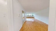 Located at 30 Esterbrooke Ave in Toronto's M2J neighbourhood, this two-bedroom, one-bathroom unit is laid out on a single floor with a practical, well-organized floor plan. Warm parquet flooring flows throughout the living spaces and bedrooms, lending a classic character to the interior's clean, white palette.

The combined kitchen and living area anchors the unit. The kitchen has been updated with white shaker-style cabinetry, subway tile backsplash, white tile flooring, and a full suite of stainless steel appliances including a refrigerator, electric range with over-the-range microwave, and dishwasher. An open doorway connects the kitchen directly to the bright living room, which features a wide bank of windows that fill the space with natural light and offer leafy outdoor views.

Both bedrooms continue the parquet flooring and are generously proportioned, each with large windows overlooking the surrounding greenery and neighbourhood. The primary bedroom is a comfortable size, with access to dedicated closet space. A second closet is also available elsewhere in the unit.

The bathroom is finished with crisp white subway tile surrounding a full soaker tub and shower combination, complemented by chrome fixtures for a clean, timeless look. A hallway connects the rooms efficiently, completing this well-appointed and move-in ready unit.