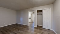 Located at 1301 SW Harrison St in Topeka, Kansas, this well-appointed one-bedroom, one-bathroom unit offers a practical and comfortable layout across a single floor. Rich wood-tone vinyl plank flooring runs throughout, providing a cohesive and modern aesthetic. The living room serves as the heart of the home, highlighted by a classic white-painted brick fireplace that adds warmth and character, flanked by windows fitted with blinds that allow for natural light control. The kitchen features white cabinetry, dark countertops, and an electric range with an overhead ventilation hood, offering a clean and functional cooking space. The bedroom is a comfortably sized retreat with its own closet and a window that brings in natural light. A dedicated closet provides additional storage, while the bathroom is equipped with a full tub-shower combination featuring built-in shelving and safety grab bars. In-unit laundry adds everyday convenience. Neutral gray walls and textured ceilings are consistent throughout, contributing to a clean and move-in-ready atmosphere. This unit provides an efficient and practical living space suited for those seeking comfort and functionality in Topeka.