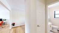 Located at 101 Martin Terr in Woodbridge, NJ, this well-appointed two-bedroom, one-bathroom home offers a thoughtfully designed single-floor layout with warm hardwood flooring throughout. The bright and airy living room welcomes natural light through large windows and features clean white walls with crown molding, creating an inviting and comfortable gathering space. Adjacent, the dining room is generously sized with a ceiling fan, gold-framed wall mirrors, and large windows overlooking greenery outside. The kitchen impresses with rich dark wood cabinetry, white quartz countertops, a classic subway tile backsplash, and a full suite of stainless steel appliances including a gas range, over-the-range microwave, and dishwasher. The primary bedroom is spacious and serene, offering two closets, ceiling fan, and hardwood floors, while the second bedroom features a window with natural views and a ceiling fan. The full bathroom is clean and modern, appointed with large-format tile flooring, a sleek white vanity with a wide mirror, and a shower-tub combination. A connecting hallway ties the layout together efficiently, completing this comfortable and well-maintained Woodbridge home.
