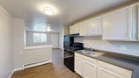 Located at 645 Wolff St in Denver, CO, this two-bedroom, one-bathroom unit offers a practical and functional single-floor layout. The kitchen and living area share an open, connected space, creating a comfortable flow for everyday living. The kitchen is equipped with white cabinetry, a gas range, a refrigerator, and a stainless steel sink, all set against durable hardwood-style flooring that extends into the living area. Natural light filters in through windows, brightening the neutral-toned walls throughout.

The primary bedroom is a well-proportioned room featuring hardwood-style flooring, a window with blinds, and baseboard heating. The second bedroom is finished with plush carpeting, a window overlooking the outdoors, and a textured ceiling, offering a cozy and quiet retreat. Both bedrooms maintain a clean, understated aesthetic with warm neutral tones.

The bathroom includes a full tub and shower combo surrounded by beige tile, a toilet, and a single vanity with a large mirror, along with a window that provides natural ventilation. Baseboard heating is present throughout the unit, ensuring consistent warmth. The space provides a straightforward, functional living environment in a convenient Denver location.