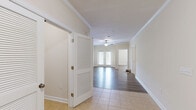 This well-appointed one-bedroom, one-bathroom residence in Duncan, SC offers a thoughtfully designed single-floor layout across a comfortable living footprint. The open living area features warm wood-style laminate flooring, crown molding, and a ceiling fan, creating a bright and welcoming atmosphere. A glass-panel door floods the space with natural light and provides access to the outdoors. The kitchen is a standout feature, showcasing rich medium-toned cabinetry, granite-look countertops, and a full suite of black appliances including a range, microwave, dishwasher, and refrigerator, all set atop light tile flooring. The bedroom is a generously sized retreat with wood-style flooring, a ceiling fan, and a large window offering natural light and exterior views. A dedicated walk-in closet with wire shelving provides ample storage. The bathroom features a warm wood vanity with granite countertops, a large mirror, and light tile flooring. A separate laundry room with washer and dryer hookups and overhead wire shelving adds everyday convenience. Crown molding and consistent neutral tones throughout unify the space with a clean, polished aesthetic.
