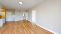 Located on the 18th floor at 195 Dundas Street in downtown London, Ontario, this modern 2-bedroom, 2-bathroom unit offers a well-designed open layout with contemporary finishes throughout. Light-toned hardwood flooring flows consistently across all living areas, complementing the neutral warm-grey walls and crisp white trim that define the unit's clean aesthetic.

The kitchen is a standout feature, equipped with stainless steel appliances including a French door refrigerator, electric range, over-the-range microwave, and dishwasher. White flat-panel cabinetry, a white subway tile backsplash, light quartz countertops, and a central island provide both style and functionality.

The open living area connects seamlessly to a private balcony through a sliding glass door, offering elevated views of the surrounding landscape. The primary bedroom is generously sized, bathed in natural light through floor-to-ceiling windows that frame striking panoramic views of the London city skyline. The second bedroom also benefits from large windows with city views.

Two bathrooms serve the unit: one features a soaker tub with a marble-style tiled surround, while the second is a clean three-piece bath with a white vanity and quartz countertop. The overall ambiance is bright, modern, and move-in ready, ideal for those seeking urban living in the heart of downtown London.