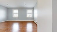 This contemporary 550 square foot apartment, located at 1401 Market St., Unit 504, Chattanooga TN 37402, offers a blend of modern amenities and thoughtful design. The heart of the home is a gleaming kitchen, showcasing crisp white cabinetry, subway tile backsplash, and stainless steel appliances. Granite countertops add a touch of luxury, while the L-shaped layout maximizes efficiency.

The living areas boast rich hardwood flooring, creating a warm and inviting atmosphere. Large windows throughout flood the space with natural light, enhancing the sense of openness. Two bedrooms feature plush carpeting for comfort underfoot, with one room offering a serene light blue wall color.

The bathroom is a study in modern simplicity, with a white vanity, granite countertop, and a spacious tub/shower combination. A striking checkerboard tile floor adds visual interest. The apartment's open concept design promotes easy flow between spaces, ideal for both everyday living and entertaining.

Storage solutions are integrated throughout, including ample kitchen cabinets and closet space in the bedrooms. The unit's single-floor layout ensures accessibility and convenience. This apartment combines style and functionality, offering a turnkey living experience in the heart of Chattanooga.