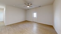 Located at 3050 Viking St in Denison, Texas, this single-story 2-bedroom, 2-bathroom home offers a clean, modern design with thoughtful finishes throughout. The open-concept living room greets you upon entry, featuring warm light wood-style flooring, a ceiling fan, and a front door with a sidelight window that fills the space with natural light.

The kitchen is a standout feature, equipped with white shaker-style cabinetry, gray quartz countertops, a subway tile backsplash, and a full suite of stainless steel appliances including a refrigerator, electric range, and over-the-range microwave. A central island with pendant lighting and an undermount sink adds both functionality and style, seamlessly connecting the kitchen to the living area.

Both bedrooms are carpeted for comfort, each featuring ceiling fans, windows with natural light, and access to closet space. The primary bedroom includes a dedicated closet.

The two bathrooms are finished with wood-look luxury vinyl flooring, white cabinetry with gray countertops, and undermount sinks. One bathroom features a tub-shower combination with white tile surround, while the other offers a more elongated vanity layout. Both are bright and cleanly designed, contributing to the home's overall fresh, contemporary feel.