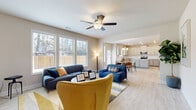 Located at 2311 Spring Rush Dr in Buford, GA, this expansive two-story home offers 7 bedrooms and 4 bathrooms across a generously sized floor plan. The main floor commands the majority of the living space and features an open-concept layout connecting the living room, dining area, and kitchen in a seamless flow. The living room is bright and welcoming, bathed in natural light from large windows and finished with light hardwood-style flooring and a ceiling fan. The kitchen is well-appointed with gray shaker cabinetry, granite countertops, a subway tile backsplash, a central island, and stainless steel appliances, including a range, microwave, and dishwasher. A dedicated pantry adds practical storage. The adjacent dining area benefits from a chandelier and direct access to the backyard. A private office on the main level provides an ideal workspace, finished with the same light flooring found throughout. The attached garage offers additional utility space. Upstairs, the secondary floor hosts additional bedrooms, including a spacious primary suite with a private bathroom featuring a soaking tub and separate shower. Secondary bedrooms are carpeted and filled with natural light. With multiple closets, a laundry room, and four hallways connecting the layout, this home is designed for comfortable, functional living.