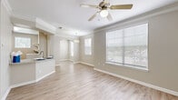 Located at Grandewood Pointe in Orlando, FL, this well-appointed 1-bedroom, 1-bathroom home offers a thoughtfully designed single-floor layout with a seamless blend of comfort and functionality. The open-concept living, dining, and kitchen area is the heart of the home, featuring light wood-style flooring, crown molding, and ceiling fans throughout. Large windows with blinds fill the space with natural light, creating a bright and welcoming ambiance. The kitchen stands out with granite countertops, white cabinetry, stainless steel appliances, and a peninsula breakfast bar framed by an elegant arched entryway. A dedicated dining area with a pendant light fixture connects gracefully to the living space. The bedroom is generously sized, finished with plush carpet, a ceiling fan, and a walk-in closet with built-in shelving. A versatile den provides additional flexible living space. The bathroom features a granite-topped white vanity, wood-style flooring, and a tiled tub-shower combination. Additional highlights include a pantry with open shelving and granite counters, multiple closets for ample storage, and an in-unit laundry area, rounding out this practical and polished home.