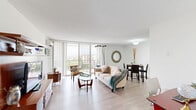 Located at 101 S Whiting St in Alexandria, VA, this well-appointed one-bedroom, one-bathroom residence offers a thoughtfully designed layout with light wood-style flooring that flows seamlessly throughout the unit. The open-concept living and dining area is the heart of the home, bathed in natural light from floor-to-ceiling sliding glass doors that lead to a private balcony with sweeping views of the surrounding cityscape and treetops — an ideal spot for relaxing or enjoying morning coffee. The kitchen is outfitted with grey shaker-style cabinetry, light granite-look countertops, a subway tile backsplash, and white appliances, including a full-size refrigerator and gas range. A dedicated pantry provides additional storage. The spacious primary bedroom features multiple closets, including mirrored sliding-door closets, a wall-mounted A/C unit, and a bright window with blinds for privacy. Altogether, five closets throughout the unit ensure exceptional storage capacity. The full bathroom includes a tub/shower combination with clean white tile. A connecting hallway ties all spaces together efficiently, completing this comfortable and functional Alexandria residence.