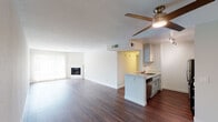 Located at 4605 Cahuenga Blvd in the North Hollywood neighborhood of Los Angeles, this single-floor unit offers a thoughtfully designed open-concept layout with consistent, modern finishes throughout. Rich hardwood-style flooring runs across the main living and kitchen areas, creating a warm and cohesive aesthetic.

The spacious living room is a standout feature, highlighted by a built-in fireplace and large windows that invite abundant natural light. A ceiling fan with an integrated light fixture adds both function and style. The open layout flows seamlessly into the kitchen, which is outfitted with white shaker-style cabinetry, light quartz countertops, a stainless steel sink, and a full suite of stainless steel appliances including a refrigerator, gas range, and microwave. A peninsula counter provides additional workspace and creates a natural division between the living and kitchen areas.

The bedroom offers a quiet retreat with plush wall-to-wall carpeting and clean white walls that maximize the sense of space and light. The bathroom is cleanly appointed with a single-sink vanity featuring a stone-look countertop, a full tub-shower combination with chrome fixtures, and a frosted window for natural ventilation. Overall, the unit presents a clean, functional, and comfortable living environment in a prime Los Angeles location.