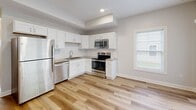 Located at 407 Tuscany Ln in Baldwinsville, NY, this two-story home offers a well-designed layout across two floors, with two bedrooms, two bathrooms, a kitchen, a hallway, and an attached garage. Throughout the living spaces, light-toned hardwood flooring creates a bright, cohesive aesthetic complemented by neutral gray walls and crisp white trim.

The kitchen is outfitted with white shaker-style cabinetry, granite-look countertops, a subway tile backsplash, and a full suite of stainless steel appliances including a refrigerator, range, microwave, and dishwasher. Large windows bring in natural light and views of the surrounding neighborhood.

Both bedrooms feature the same warm wood flooring and double-door closets for ample storage. The primary bedroom is a well-proportioned retreat equipped with a ceiling fan. The second bedroom also benefits from a ceiling fan and generous natural light through large windows. The bathrooms are finished cleanly in white, with one featuring a white vanity with shaker-style cabinetry, a single sink, and a mirror with overhead lighting.

The attached garage includes an automatic garage door opener and provides convenient enclosed parking or additional storage. The overall design is clean, modern, and move-in ready.