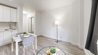 Located at 3777 Rue Saint-Urbain in the heart of Montréal's vibrant Plateau-Mont-Royal neighbourhood, this efficiently designed studio unit makes smart use of its compact footprint. The open-concept main area seamlessly integrates a living space, dining area, and kitchen into a single, cohesive room. Light wood laminate flooring runs throughout, lending warmth and continuity to the space, while bright white walls and recessed and ambient lighting create a clean, airy atmosphere.

The kitchen is well-appointed with white shaker-style cabinetry extending to the ceiling for maximum storage, and includes a full-size refrigerator, electric range, and ample counter space. A small dining table with seating flows naturally from the kitchen, making everyday meals both practical and comfortable. The living area accommodates a sofa and glass coffee table, offering a relaxed setting within the open layout.

The bathroom is thoughtfully finished with large-format grey tile on both the walls and floor, a soaker tub with an overhead shower, a white vanity with an integrated sink, and a mirrored medicine cabinet — delivering a clean, modern aesthetic. Throughout the unit, the design prioritizes functionality and simplicity, making this a practical and well-presented space in one of Montréal's most sought-after neighbourhoods.