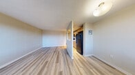 Located at 4701 E Mississippi Ave in Glendale, Colorado, this one-bedroom, one-bathroom unit offers a practical and well-organized single-floor layout. The living room greets residents with light-toned wood-look flooring, neutral walls, and two windows fitted with horizontal blinds that invite natural light. A wall-mounted A/C unit and baseboard heaters ensure year-round comfort. The kitchen is defined by a half-wall pass-through, warm honey-toned cabinetry, a striking herringbone tile backsplash, a black refrigerator, and track lighting overhead — giving it a stylish, functional character. An adjacent dining area flows naturally from the kitchen. The bedroom is finished with plush carpeting, a window with outdoor views, a baseboard heater, and a generous double-door closet providing ample storage. The bathroom features full ceramic tile surround on the soaking tub and a window above for ventilation and natural light. A dedicated closet and an additional unclassified room round out the unit's storage and utility options. Throughout the space, a consistent neutral color palette and clean finishes create a cohesive, move-in-ready ambiance suited to comfortable everyday living.