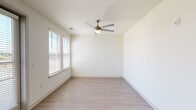 Located at 6101 Chamberlain Ln in Louisville, Kentucky, this single-floor unit offers a clean, contemporary design highlighted by light-toned wood-style flooring that runs consistently throughout the space, creating a cohesive and polished aesthetic.

The living area is open and well-lit, featuring multiple windows dressed with white horizontal blinds that allow ample natural light to filter in. A exterior-facing door with a sidelight panel provides both access and additional brightness. Ceiling fans with integrated lighting are present in the bedroom areas, contributing to both comfort and visual continuity.

The kitchen is a standout feature, showcasing bold slate-blue cabinetry paired with white countertops and a white subway tile backsplash. Stainless steel appliances — including a range, built-in microwave, and dishwasher — complete the modern, functional design. The contrasting color palette gives the kitchen a distinctive and contemporary character.

The bathroom is finished with a wide white vanity topped with a clean white surface and framed by a large wood-trimmed mirror. A glass-enclosed walk-in shower with neutral tile accents adds a refined touch, while light tile flooring ties the space together with a spa-like simplicity.

Overall, the unit presents a bright, modern atmosphere with thoughtful finishes throughout.