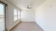 Located at 6101 Chamberlain Ln in Louisville, Kentucky, this single-floor unit offers a clean, contemporary design highlighted by light-toned wood-style flooring that runs consistently throughout the space, creating a cohesive and polished aesthetic.

The living area is open and well-lit, featuring multiple windows dressed with white horizontal blinds that allow ample natural light to filter in. A exterior-facing door with a sidelight panel provides both access and additional brightness. Ceiling fans with integrated lighting are present in the bedroom areas, contributing to both comfort and visual continuity.

The kitchen is a standout feature, showcasing bold slate-blue cabinetry paired with white countertops and a white subway tile backsplash. Stainless steel appliances — including a range, built-in microwave, and dishwasher — complete the modern, functional design. The contrasting color palette gives the kitchen a distinctive and contemporary character.

The bathroom is finished with a wide white vanity topped with a clean white surface and framed by a large wood-trimmed mirror. A glass-enclosed walk-in shower with neutral tile accents adds a refined touch, while light tile flooring ties the space together with a spa-like simplicity.

Overall, the unit presents a bright, modern atmosphere with thoughtful finishes throughout.