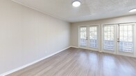 Located at 1302 24th St W in Austin, TX, this well-appointed one-bedroom, one-bathroom unit offers a thoughtfully designed layout across a single floor. Light wood-style flooring flows consistently throughout, creating a clean and cohesive aesthetic. The open living area is bright and welcoming, with a textured ceiling and a front entry door that anchors the space.

The kitchen is a standout feature, showcasing crisp white shaker cabinetry, light quartz countertops, and a classic subway tile backsplash. Stainless steel appliances — including a gas range, over-the-range microwave, dishwasher, and refrigerator — complete the functional and stylish cooking space.

The bedroom is a comfortable, well-proportioned room featuring a ceiling fan, a window with blinds that allows natural light in, and easy access to the hallway and closet. French doors in the adjacent living area offer views of the surrounding greenery, adding a refreshing connection to the outdoors.

The bathroom is clean and simply appointed, featuring a tiled tub-shower combination with chrome fixtures. A hallway and closet round out the unit's layout, providing practical storage solutions. Neutral wall tones throughout contribute to a bright, move-in-ready feel ideal for those seeking a streamlined living space in Austin.