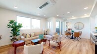 Located at 3943 Oregon St in San Diego's vibrant North Park neighborhood, this modern 2-bedroom, 2-bathroom residence offers a thoughtfully designed single-level layout. The open-concept living and dining area is bathed in natural light from large windows with neighborhood views, featuring light hardwood-style flooring, recessed lighting, and a ceiling-mounted HVAC unit. A sliding glass door leads to a private balcony, extending the living space outdoors. The contemporary kitchen is appointed with crisp white shaker cabinetry, warm wood-toned lower cabinets, a glossy white tile backsplash, quartz countertops, stainless steel appliances including a gas range, built-in microwave, dishwasher, and refrigerator. A compact dining area sits adjacent to the kitchen. The primary bedroom features a full-wall built-in wardrobe and an en-suite bathroom with a double-sink vanity with wood-toned cabinetry and quartz countertop. The second bedroom is cozy with a bright window and hardwood-style flooring. The second bathroom includes a single vanity and a tub-shower combo with white tile surround. Consistent finishes throughout create a clean, cohesive aesthetic suited to modern living.