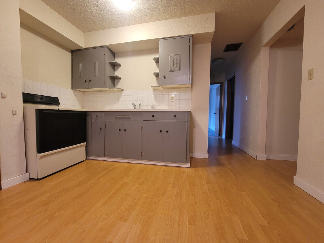 Kitchen and hall to bedrooms and bath. Stainless steal refrigerator to the right - 6202 SE Jennings Ave