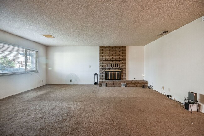 Building Photo - 3 bedroom, 2 bath with large living room and brick fireplace.  Good size kitchen with tons of cab...