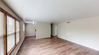 Located at 549 5th St SE in Barberton, Ohio, this single-floor, 2-bedroom, 1-bathroom home offers a straightforward and functional layout. Wood-look flooring runs consistently throughout the entire space, providing a cohesive and easy-to-maintain aesthetic.

The living room is a generously sized open area with neutral-toned walls and clean white ceilings, allowing for flexible furniture arrangements. It connects to a combined dining room and kitchen, making the space practical for everyday living. A hallway links the main living areas to the private quarters, keeping the layout well-organized.

Both bedrooms are comfortable in size, each featuring ceiling fans with integrated lighting and built-in closets with hanging rods for convenient storage. The primary bedroom offers a bit more room and benefits from natural light via a window overlooking the outdoors. One of the bedrooms showcases a distinctive painted cinder block accent wall, adding a subtle industrial character to the space.

The bathroom is clean and functional, featuring a tub-shower combination with tiled surround, a window with blinds that brings in natural light, and a vanity with sink. Additional storage is well-served by four closets distributed throughout the home. A dedicated utility room and hallway round out the layout, ensuring practical everyday functionality throughout this well-maintained property.