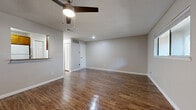 Located at 400 W Saint Elmo Rd in Austin, TX, this one-bedroom, one-bathroom unit offers a well-organized single-floor layout. The combined living and dining area serves as the heart of the home, featuring warm wood-style flooring, neutral gray walls, a textured ceiling, and a ceiling fan with light. A pass-through window connects this open space directly to the kitchen, enhancing the sense of flow and communication between rooms. Natural light enters through a front-facing window, while recessed lighting and ceiling-mounted fixtures provide additional illumination throughout.

The galley-style kitchen is efficiently designed with rich wood cabinetry, granite-look countertops, a mosaic tile backsplash, and white appliances including a dishwasher, electric range, and refrigerator. A pantry provides added storage convenience.

The bedroom is carpeted and bathed in natural light from multiple windows that frame views of surrounding trees. A ceiling fan keeps the space comfortable, and two closets — including a walk-in — offer generous storage. The unit also includes a dedicated utility room, a full bathroom, and additional closet space, rounding out a practical and comfortable layout ideal for Austin living.