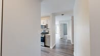 Located at 400 E South Water Street in Chicago's sought-after Streeterville neighborhood, this modern residence offers a thoughtfully designed single-floor layout with clean, contemporary finishes throughout. The kitchen is a standout feature, equipped with stainless steel appliances including a gas range, built-in microwave, and dishwasher, complemented by sleek gray shaker cabinetry, white quartz countertops, and a distinctive elongated hexagonal tile backsplash. Hardwood-style flooring flows through the main living and kitchen areas, creating a cohesive and polished aesthetic. The bedroom is generously proportioned, featuring plush carpeting, a built-in closet, and a large floor-to-ceiling window that frames sweeping views of the Chicago skyline, flooding the space with natural light. The bathroom is finished to a high standard, showcasing a white quartz vanity with an undermount sink, gray cabinetry with brushed nickel hardware, a mirrored medicine cabinet, and a full soaking tub with an overhead shower. Neutral tones and clean lines throughout lend the space a bright, airy ambiance, while its prime location places residents steps from the Chicago Riverwalk, Millennium Park, and the best of downtown Chicago.