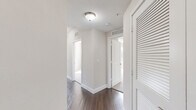 Located in Pembroke Pines, FL, this single-floor unit offers four bedrooms and two bathrooms with a well-designed, functional layout. Dark hardwood flooring flows throughout the main living areas and hallways, lending warmth and continuity to the space. The open kitchen and dining area serves as the heart of the home, featuring white shaker cabinetry, granite countertops, a curved kitchen island with pendant lighting, and a full suite of stainless steel appliances including a side-by-side refrigerator, range, microwave, and dishwasher. A glass door brings in natural light, enhancing the kitchen's bright, airy feel. The living and dining area is generously proportioned, with multiple windows, a ceiling fan, and abundant natural light creating a welcoming atmosphere. Each of the four bedrooms is finished with plush carpeting, neutral walls, and windows with views of lush Florida greenery. The spacious primary bedroom offers ample room to accommodate full-size furnishings. The two bathrooms are finished with large-format tile flooring and white subway tile surrounds. The primary bath features both a glass-enclosed walk-in shower and a soaking tub, while the second bath offers a tub-shower combination with granite vanity countertops. Hallways connect all rooms efficiently, completing a practical and comfortable floor plan.