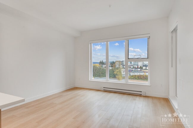 Photo du bâtiment - Contemporary 1-Bedroom + Den Home at The D...