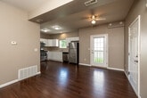 Located at 4051 W Burlington Ave in Burlington, Iowa, this well-designed two-bedroom, one-bathroom single-floor unit offers a functional and comfortable layout. The open-concept kitchen and living area serves as the heart of the home, featuring rich hardwood-style flooring that extends throughout the main living spaces. The kitchen is equipped with stainless steel appliances — including a range with microwave, dishwasher, and refrigerator — complemented by crisp white cabinetry, light countertops, and a double-basin sink beneath a window that brings in natural light. The living area is bright and open, with neutral warm-toned walls and a ceiling fan overhead. Both bedrooms are carpeted and finished with the same neutral palette, each featuring six-panel doors and windows that allow natural light and outdoor views. The primary bedroom includes its own closet, while additional closets throughout the unit provide ample storage. The bathroom is clean and functional, with a full tub-shower combination and hardwood-style flooring. The unit also includes a dedicated laundry area and utility room, rounding out a practical and well-appointed living space.