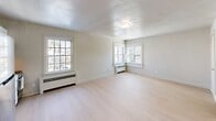 Located at 1312 Cleveland Ave NW in Canton, Ohio, this single-floor unit offers an efficiently designed layout that maximizes every square foot. The main living area is bright and open, finished with light hardwood flooring and neutral-toned walls that create a clean, airy atmosphere. A textured ceiling and flush-mount light fixture add classic character, while multiple windows with white trim invite ample natural light and views of the surrounding neighborhood. Baseboard heating units are positioned throughout the space for year-round comfort.

The kitchen is neatly integrated into the living area and features white cabinetry, a stainless steel stove and refrigerator, and a tile backsplash — providing all essential amenities in a compact, functional footprint. An additional room off the main space offers flexibility for use as a bedroom or office, with hardwood flooring and a classic paneled door.

The full bathroom is finished with white subway tile surrounding a tub-shower combination, a natural light-providing window, wall sconce lighting, and a clean white vanity — delivering a bright and timeless aesthetic. A spacious walk-in closet with dual hanging rods and built-in shelving rounds out the unit, offering generous storage relative to the overall footprint of the space.